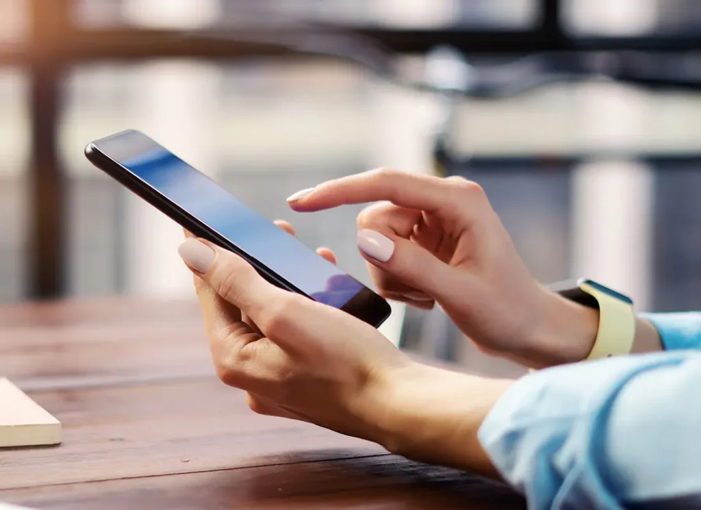 Woman using an iPhone to request a policy change on her insurance policy